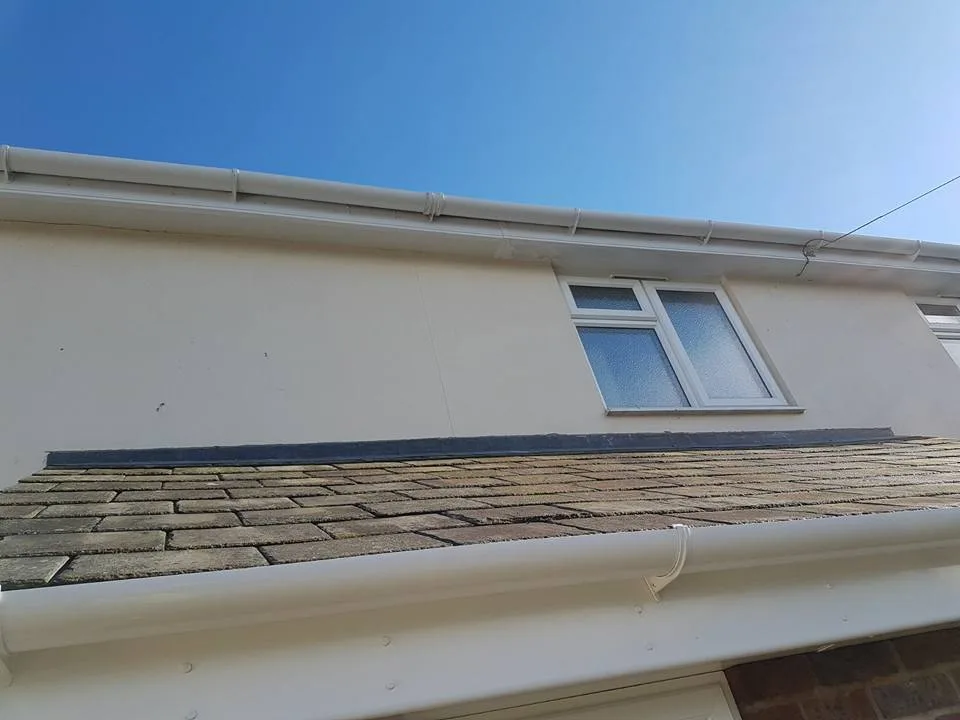 New white fascia, soffit and guttering fitted to a dormer with a slate roof