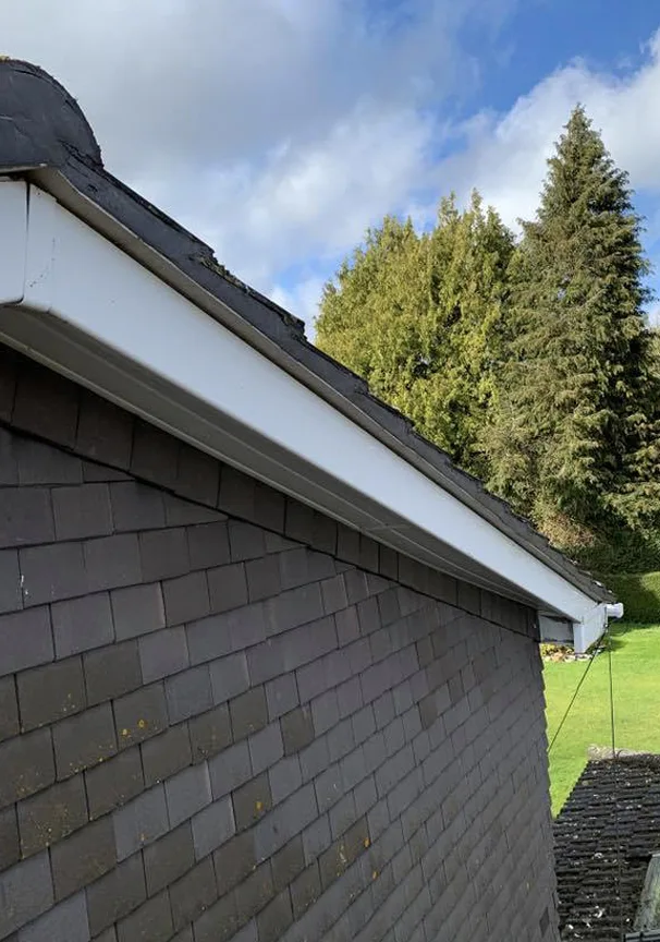 Slate roof edge with new white fascia and soffit