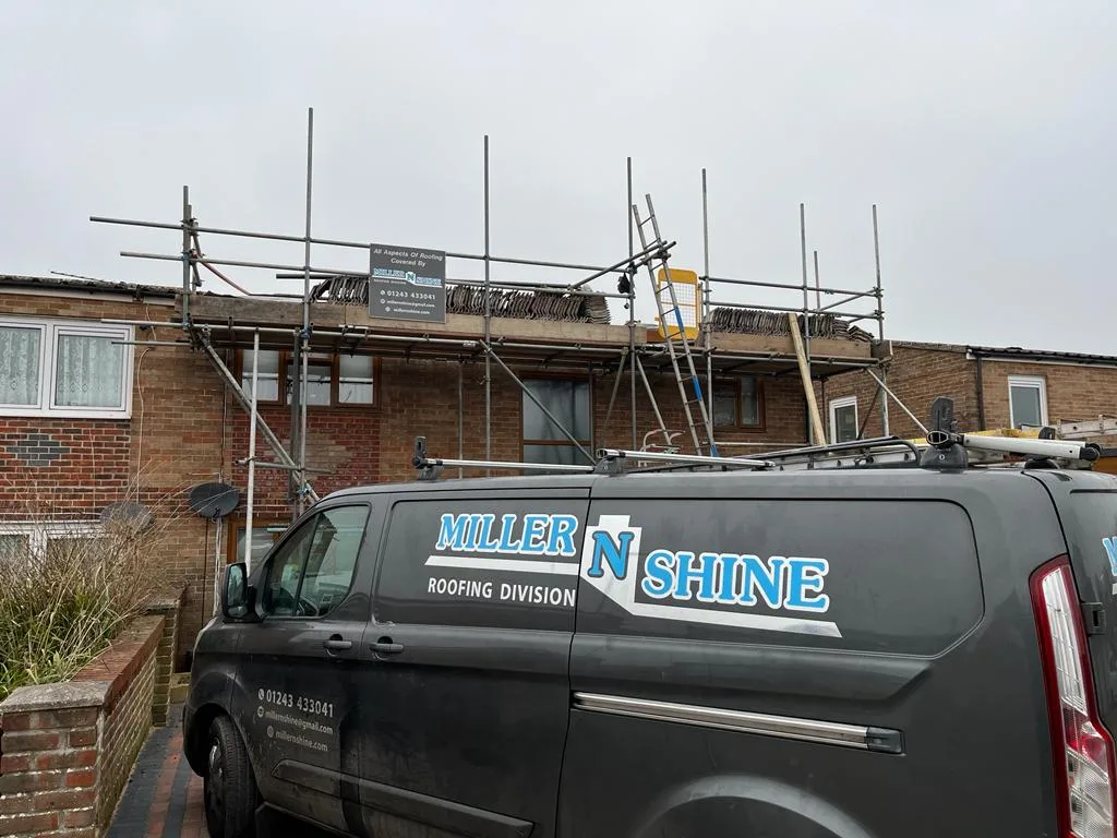 The Miller 'N' Shine roofing division van outside a scaffolded house